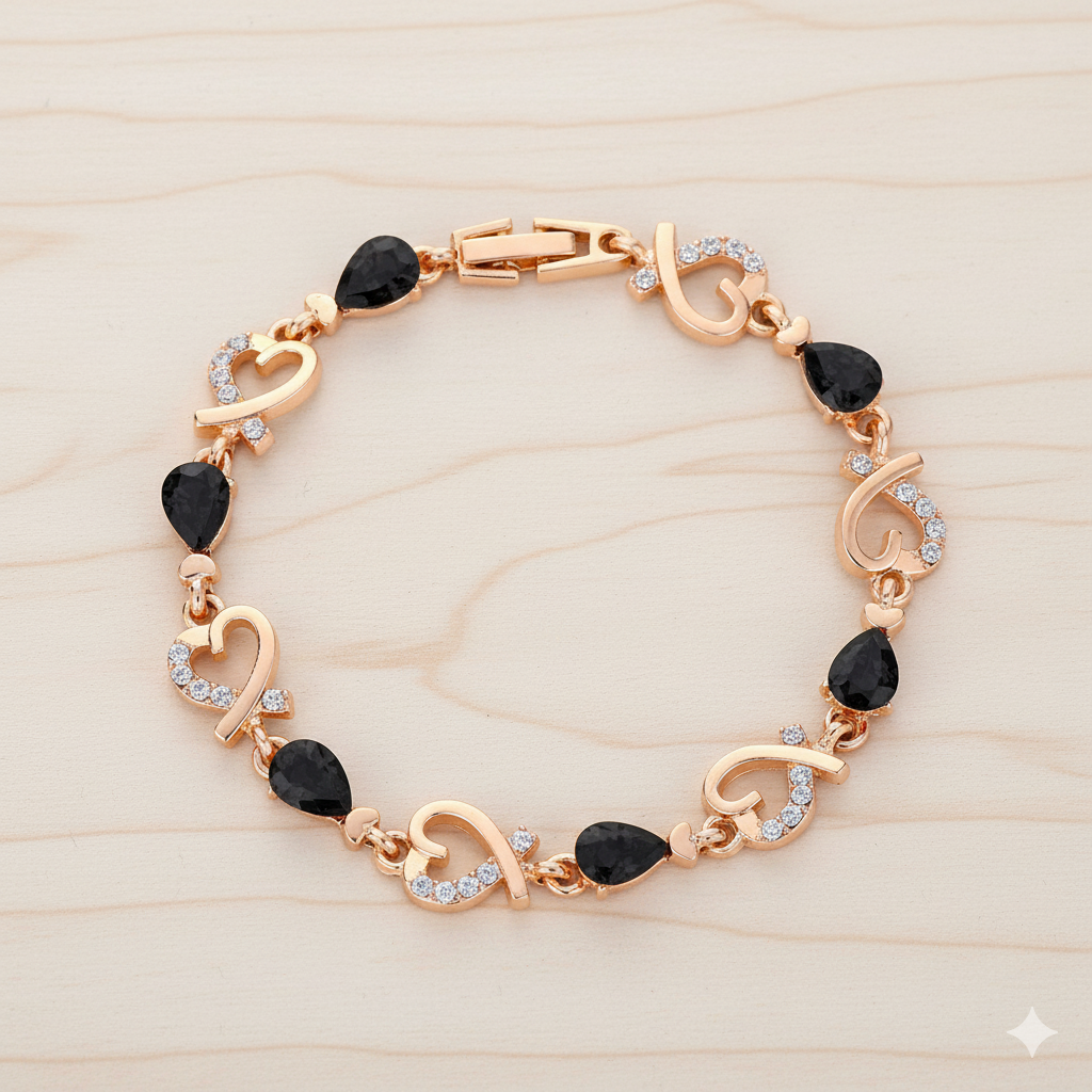 Rose gold bracelet with black gemstones on a light wood background
