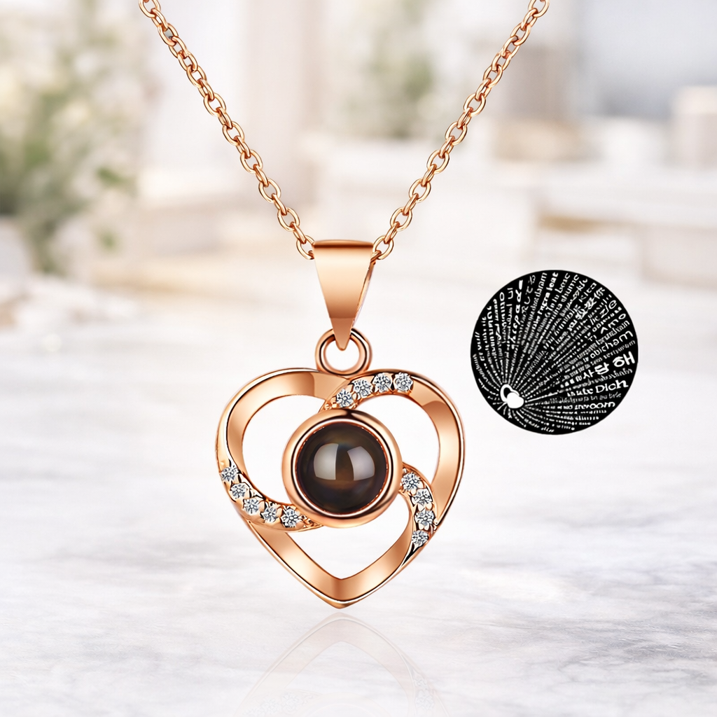 Rose gold heart-shaped necklace with a dark gemstone on a light background