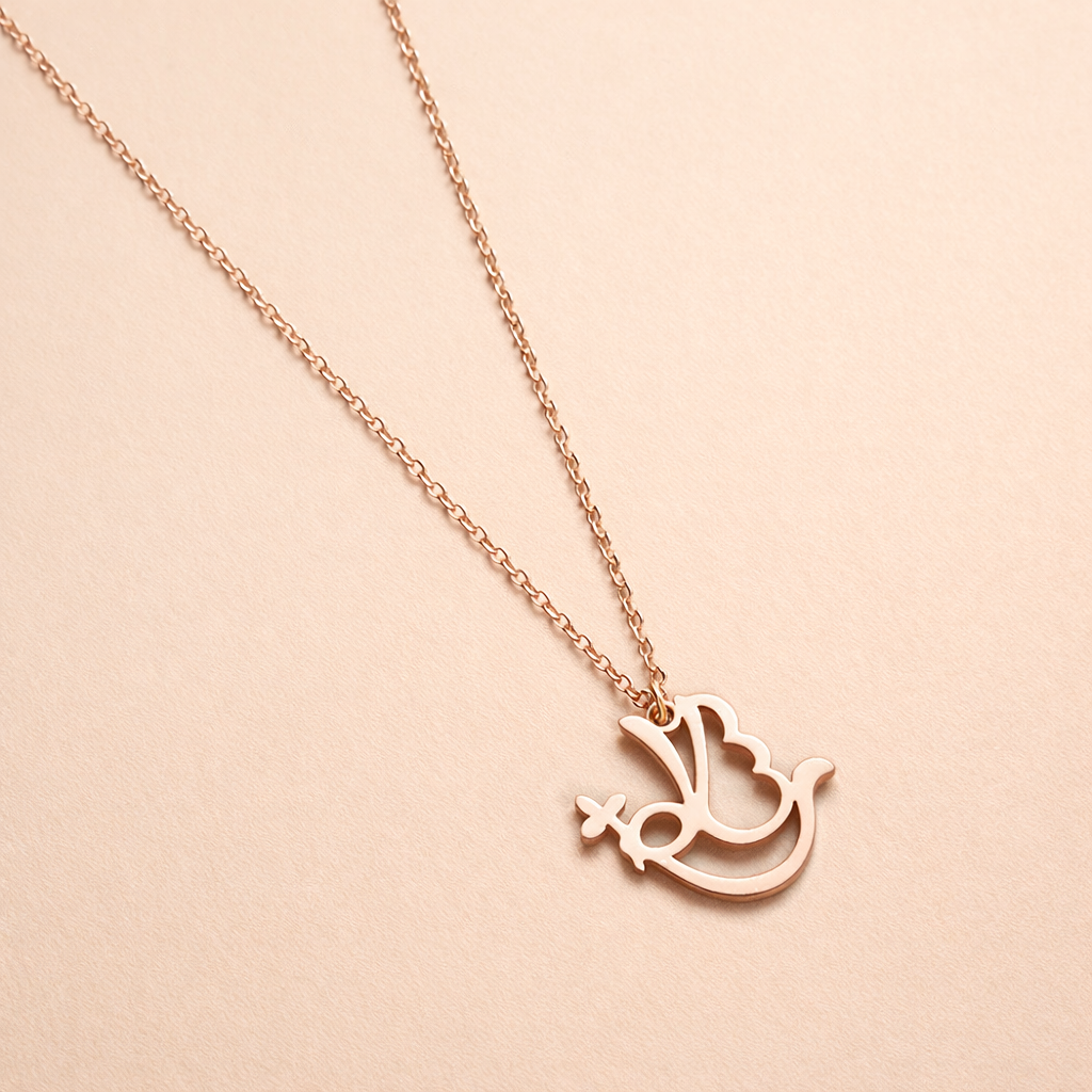 Rose gold necklace with a bird-shaped pendant on a beige background