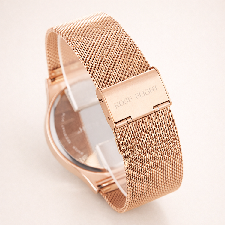 Rose gold watch with mesh band on a light background