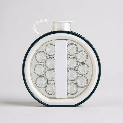 Round jewelry display with clear stones on a white background