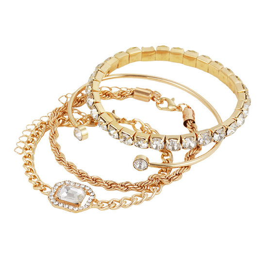 Set of gold bracelets with various designs on a white background