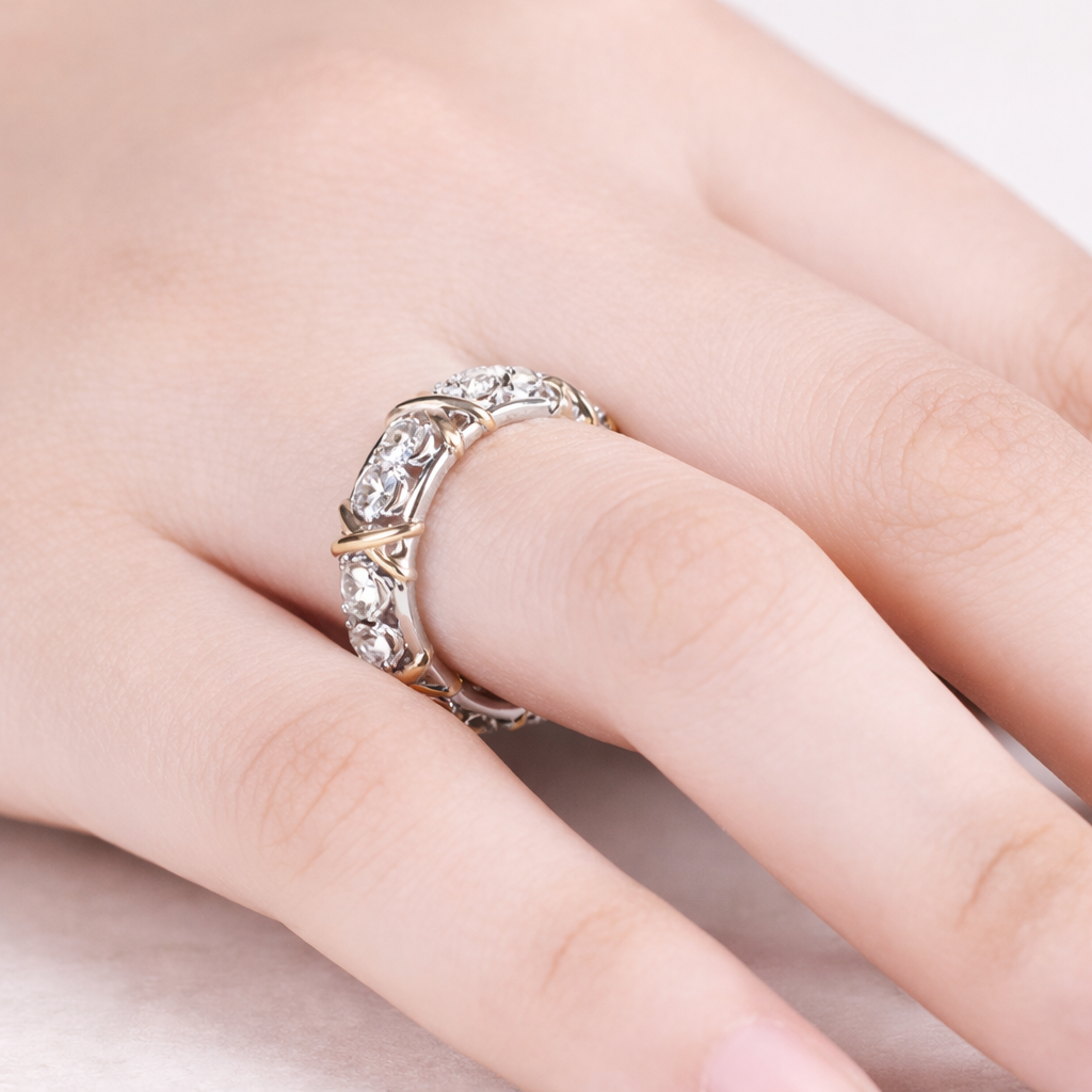 Silver ring with gemstones on a finger against a neutral background