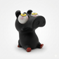 A black cartoon pig figurine with large white eyeballs featuring red veins and yellow irises, sitting on a white background.