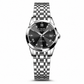 Silver wristwatch with black dial on a white background