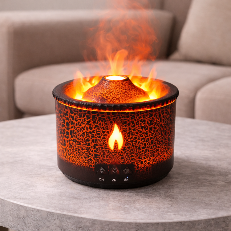 Tabletop fire pit with flames on a gray surface, blurred sofa in the background