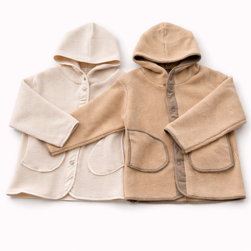 Two hooded jackets, one beige and one cream, on a white background