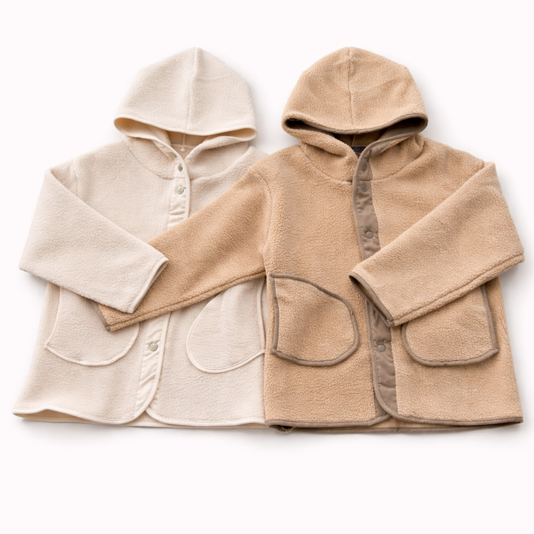 Two hooded jackets, one beige and one cream, on a white background