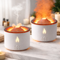 Two white ceramic diffusers with flame design on a marble surface. YELLOW