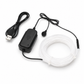Black electronic device with USB cable and white coiled cable on a white background