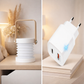 White Collapsible lantern and power adapter on a beige background
