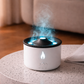 White and black humidifier emitting steam on a speckled surface with a blurred background