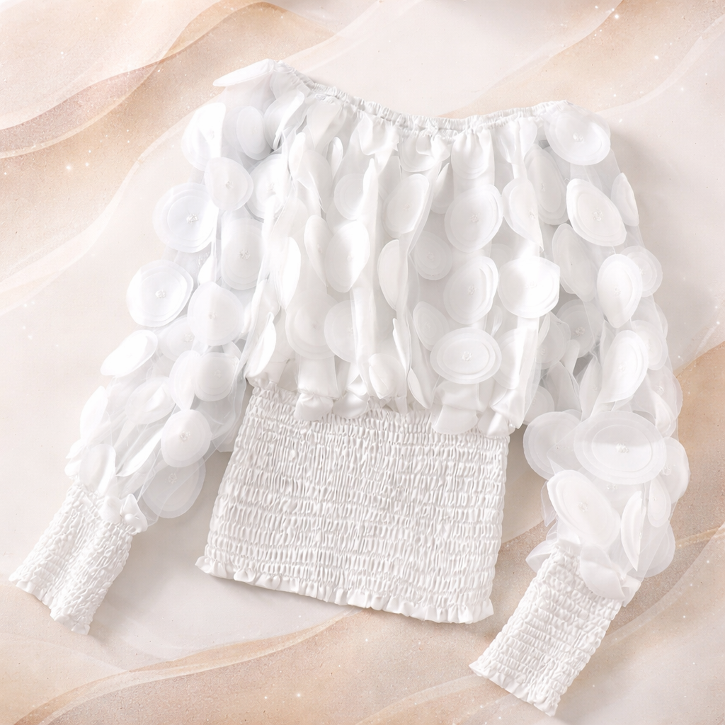 White blouse with ruffled sleeves on a light pink background