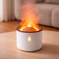White flameless candle with orange glow on a wooden surface