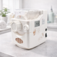 White pasta maker on a marble surface with a blurred background