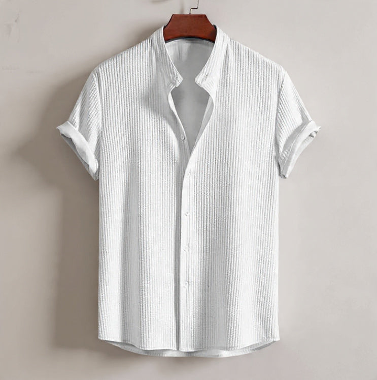White short-sleeve shirt on a hanger against a plain background