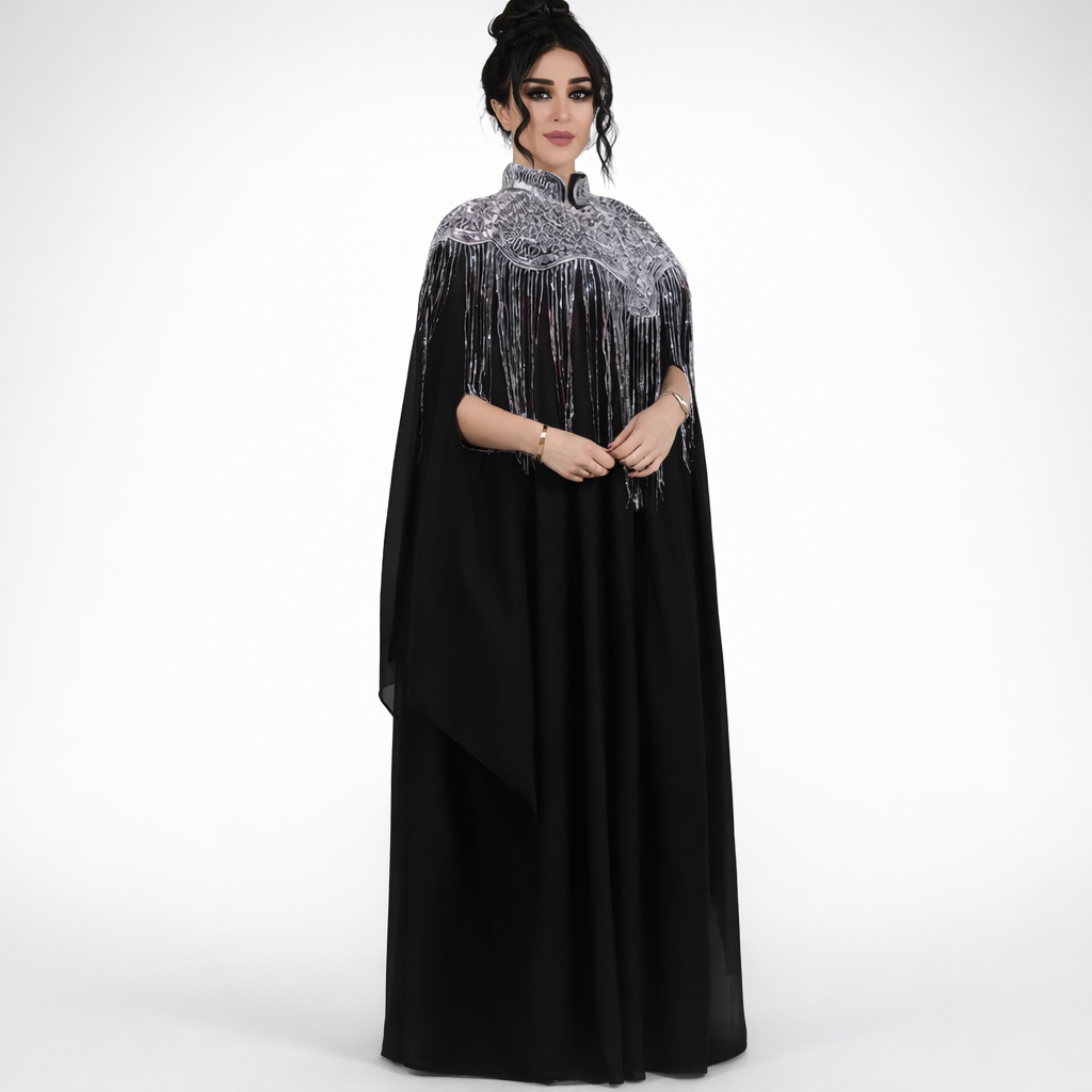 Woman wearing a black dress with silver embellishments on a white background