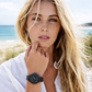 Woman wearing a black watch on a beach