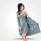 Woman wearing a light blue lace nightgown with matching robe on a white background