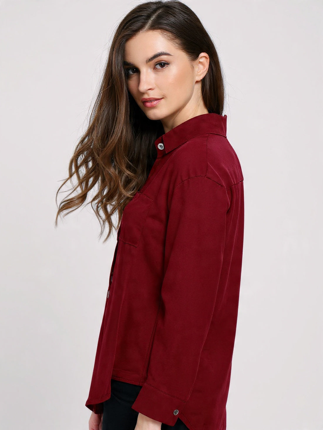 Woman wearing a red shirt against a white background