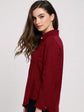 Woman wearing a red shirt against a white background