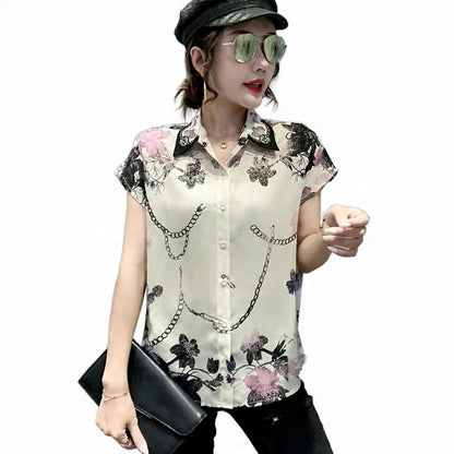 Woman wearing a sleeveless floral and chain-patterned blouse on a white background