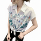 Woman wearing a white blouse with colorful pattern on a white background..