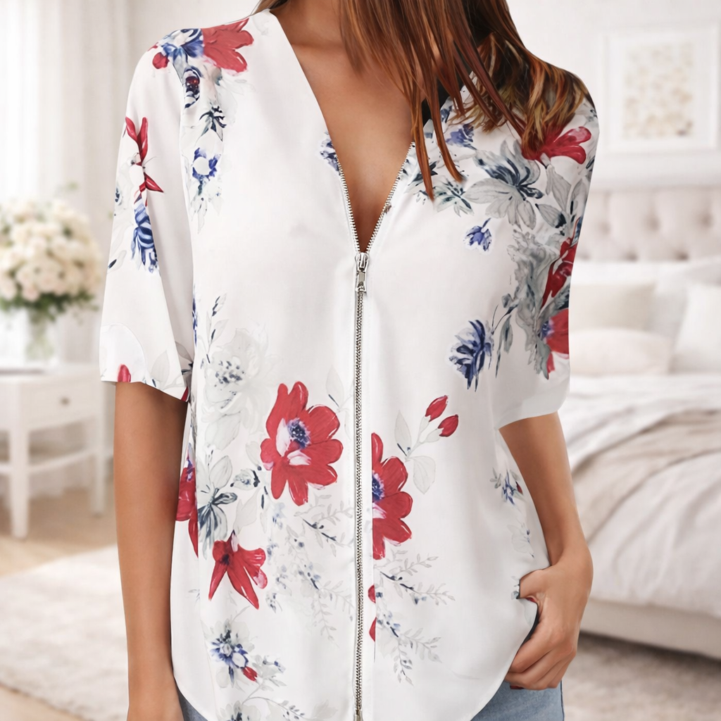 Woman wearing a white floral blouse in a bedroom setting