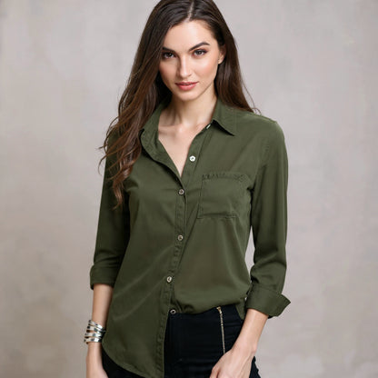 Woman wearing an olive green shirt against a neutral background