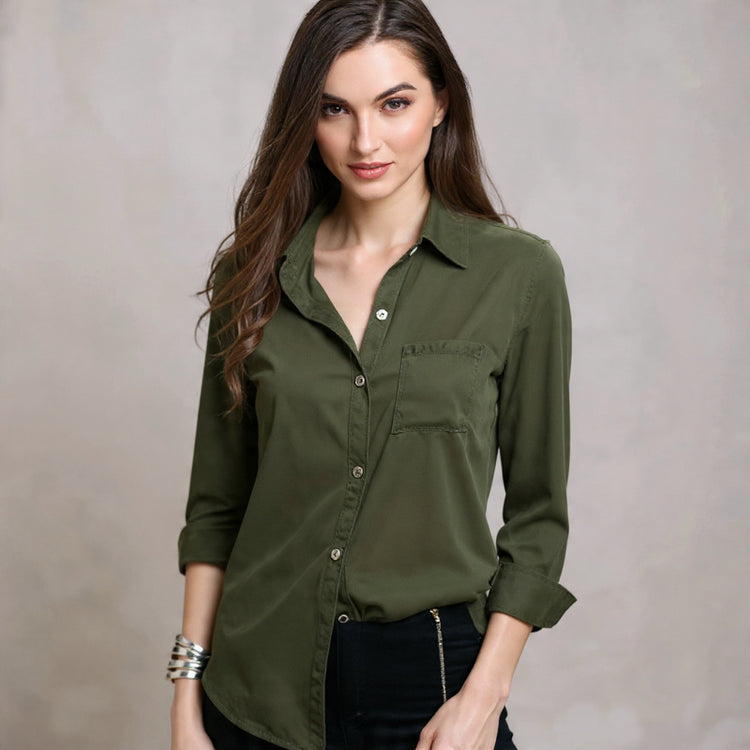 Woman wearing an olive green shirt against a neutral background