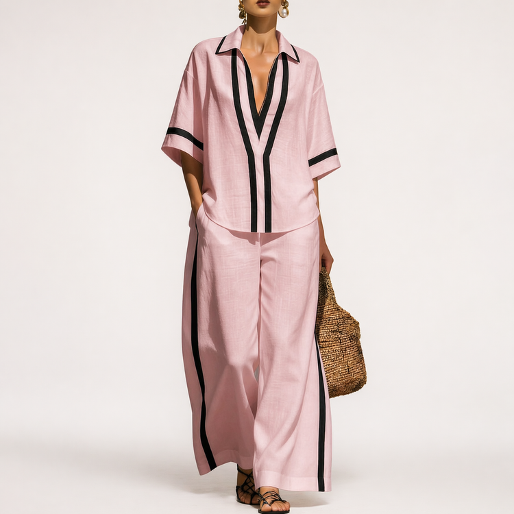 Woman wearing a pink outfit with black accents on a white background