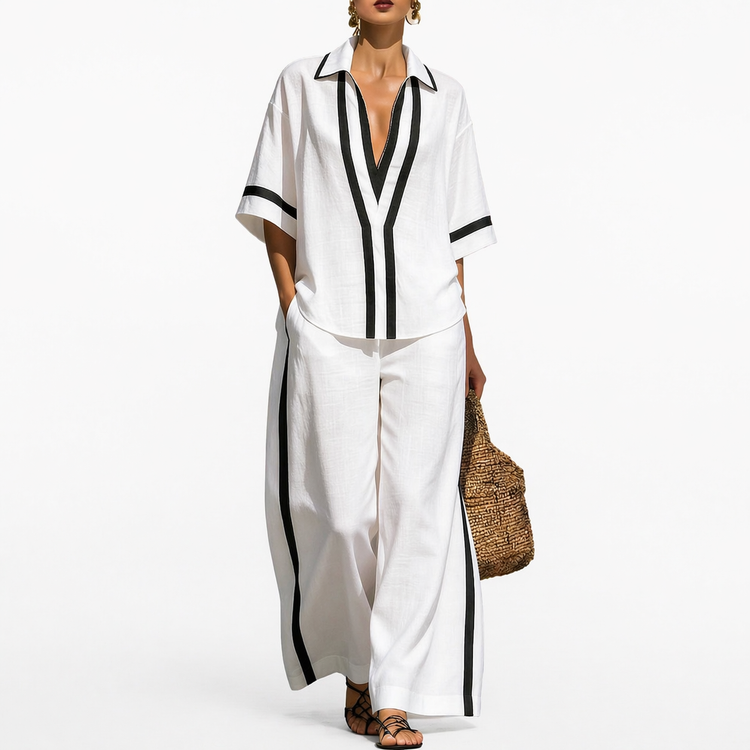 Woman wearing a white outfit with black accents on a white background