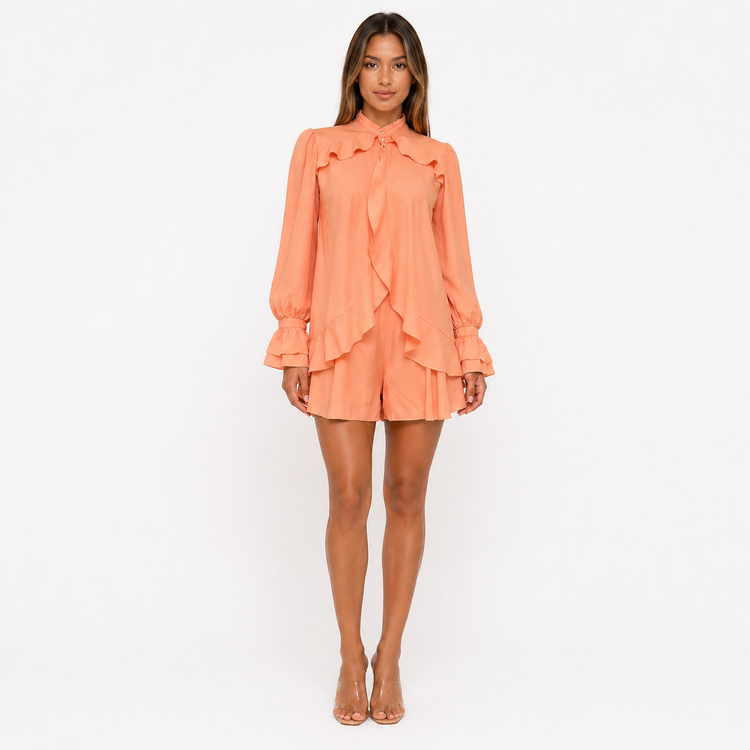Woman wearing an orange ruffled dress on a white background