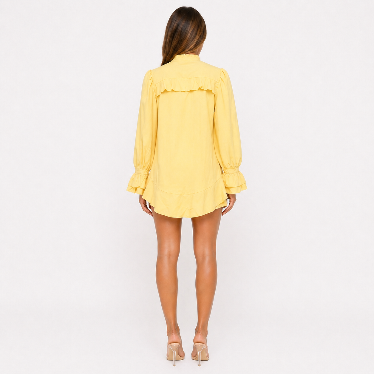 Person wearing a yellow dress on a white background