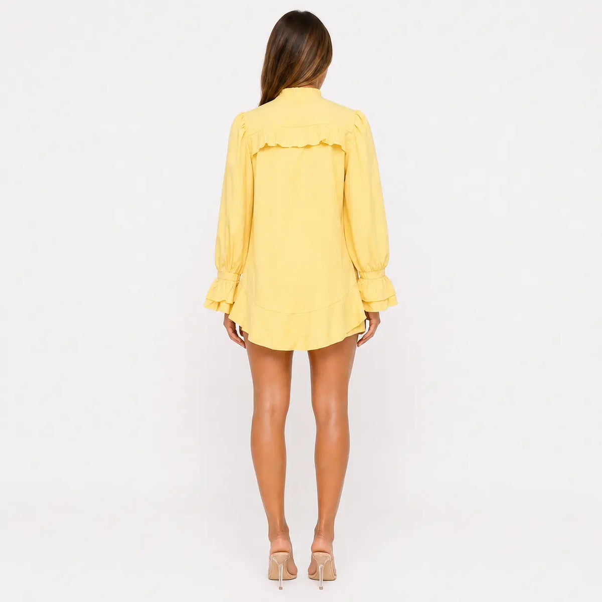 Person wearing a yellow dress on a white background