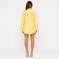 Person wearing a yellow dress on a white background