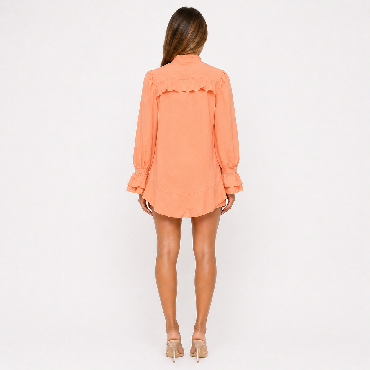 Woman wearing an orange dress on a white background