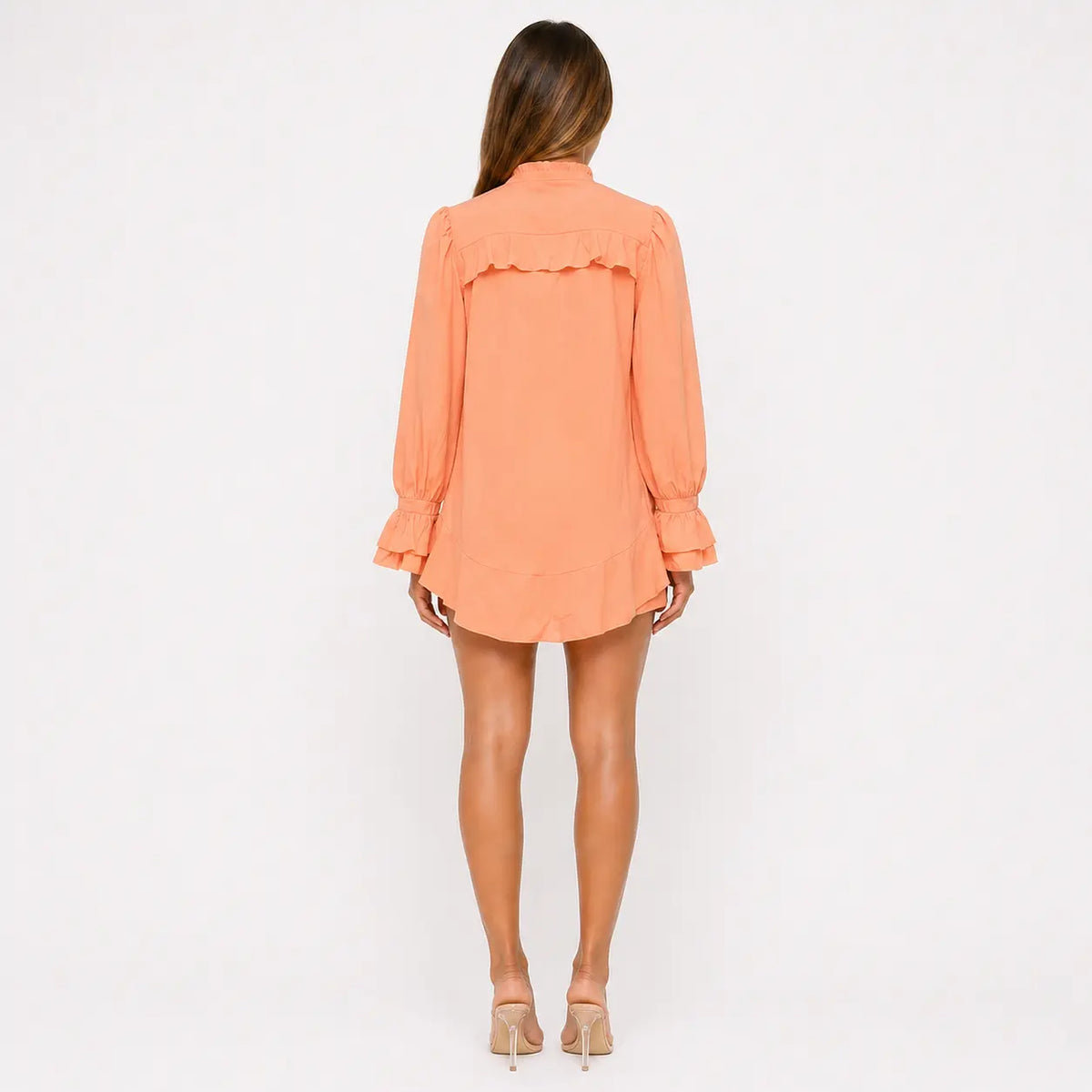 Woman wearing an orange dress on a white background
