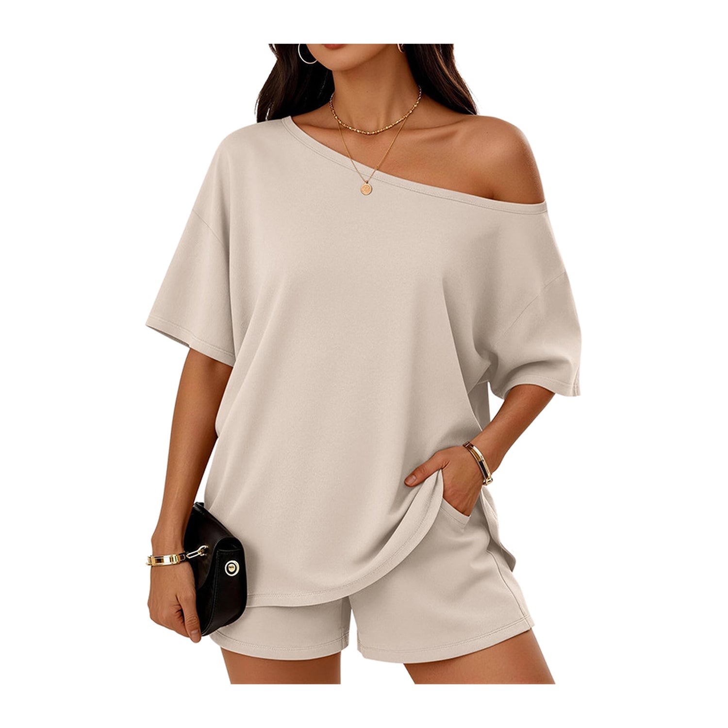 Woman wearing a beige off-shoulder top and shorts set on a white background