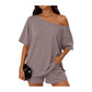 Woman wearing a gray off-shoulder top and shorts set on a white background