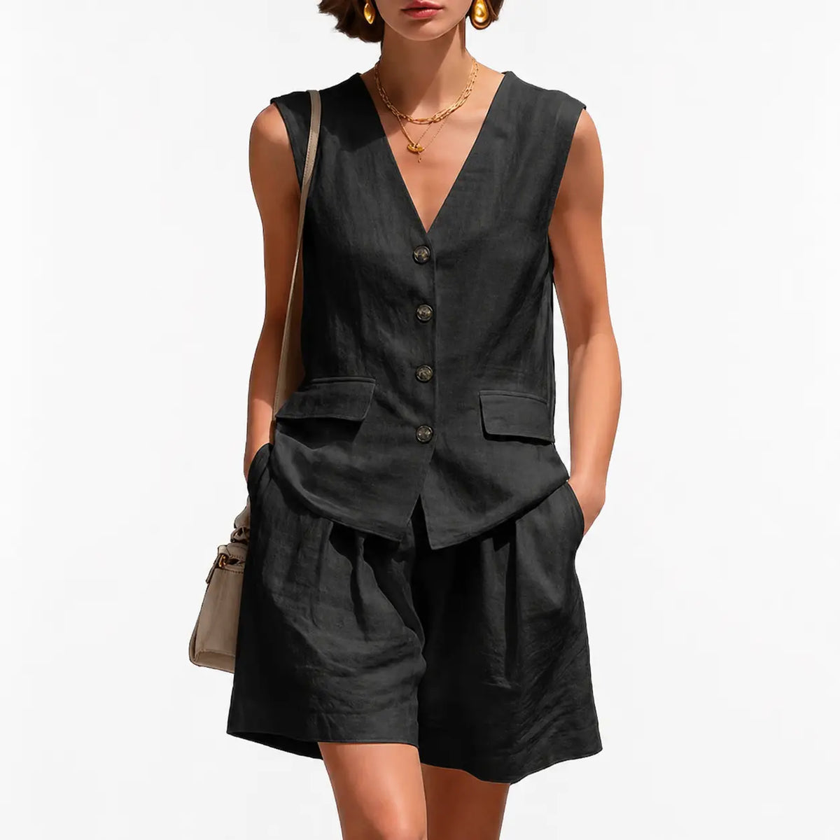 Woman wearing a black sleeveless top and shorts with a beige handbag on a white background