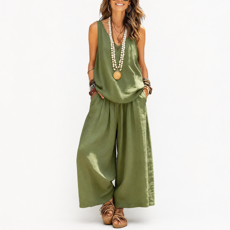 Woman wearing an olive green jumpsuit with wide-leg pants on a white background