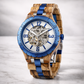 Wooden watch with blue accents on a light gray background