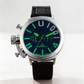 Wristwatch with black strap and green glowing face on a white background