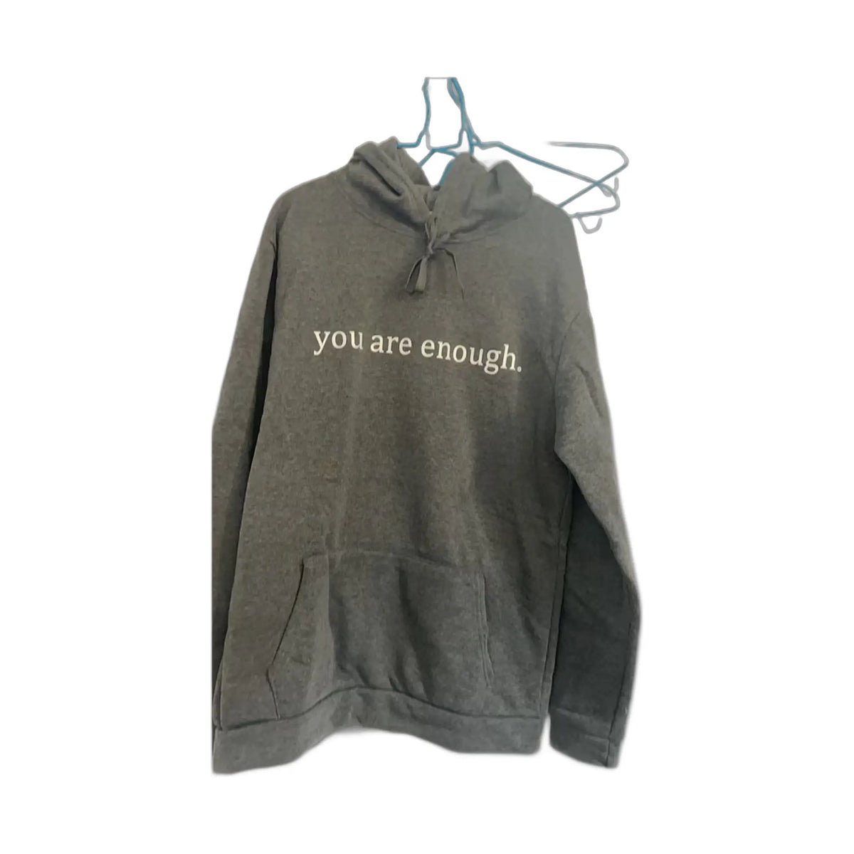 gray hoodie with white text saying you are enough on a white background