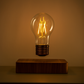 floating electric light bulb above wooden board for interior decorations in the room on the bedside drawer