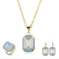 Jewelry set with gold necklace, ring, and earrings featuring blue gemstones on a white background.