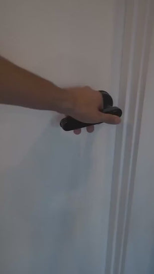 Black Smart door lock system with digital keypad and smartphone app in use