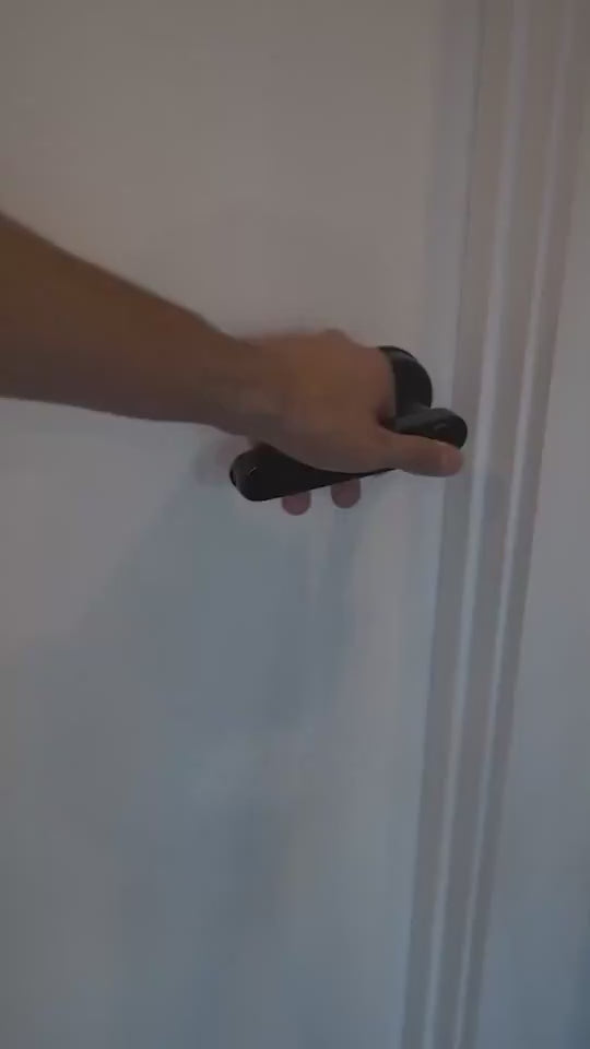 Black Smart door lock system with digital keypad and smartphone app in use