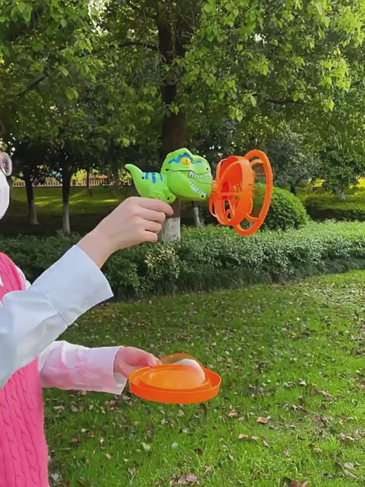 1Green dinosaur-shaped bubble gun with bubbles in a grassy outdoor setting